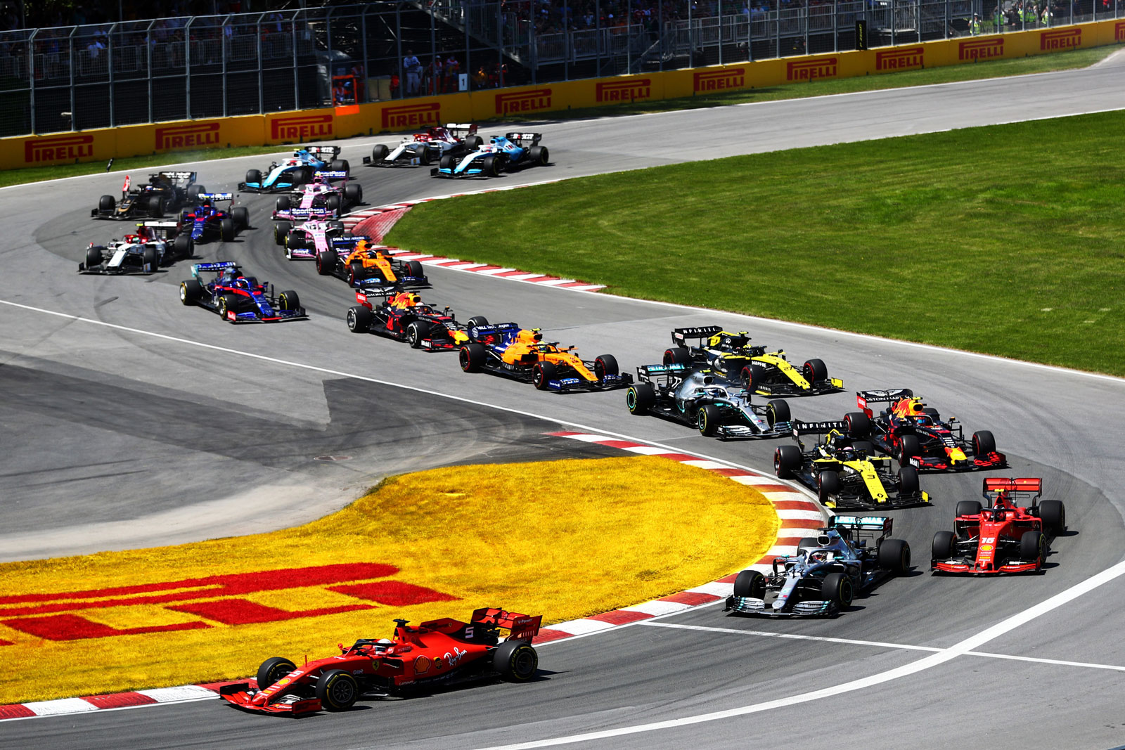A Ferrari leads a train of 19 other Formula 1 cars around a chicane at the Canadian Grand Prix